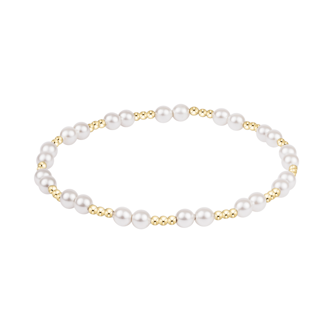 Pearl bracelet with gold accents on a white background