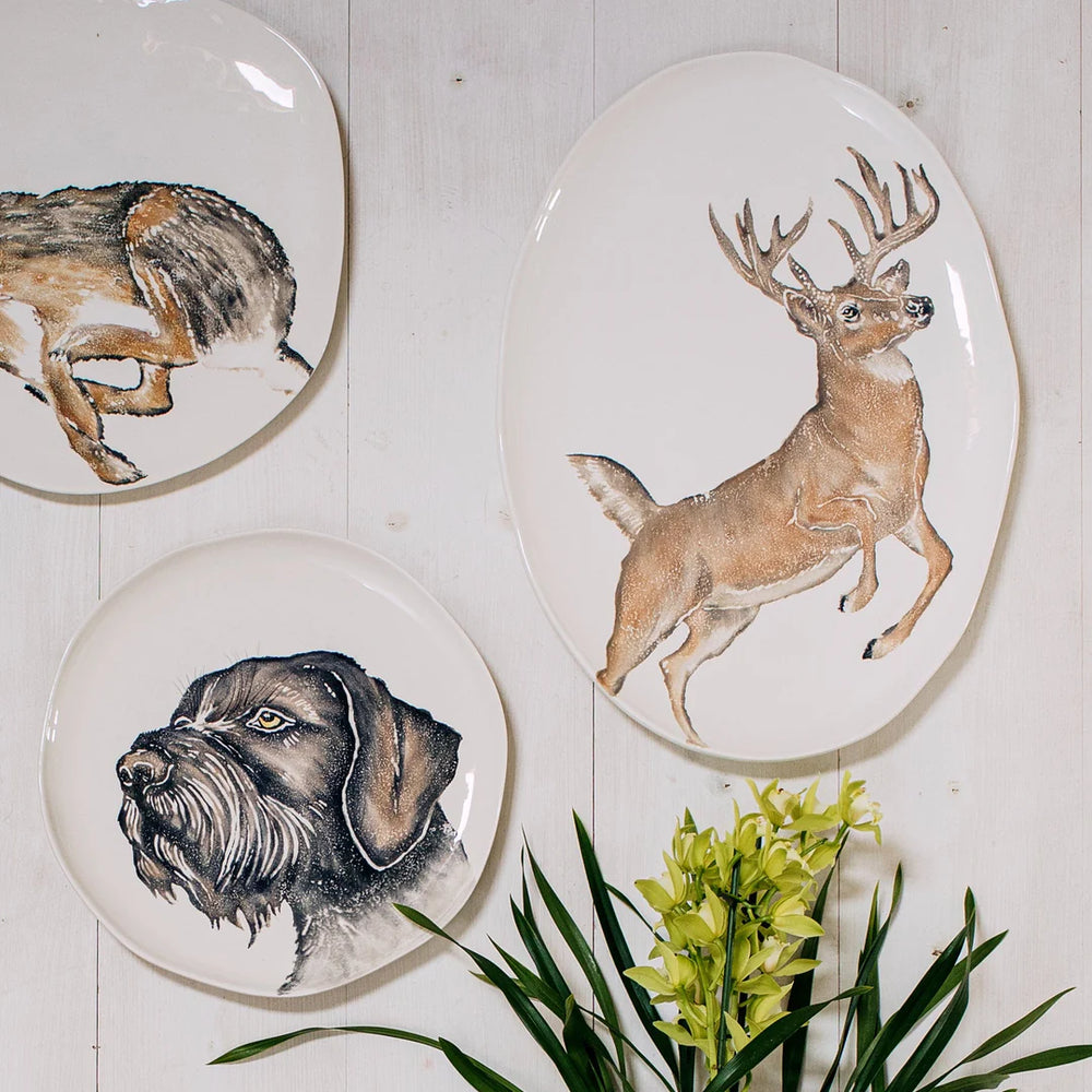 deer platter shown with dog and rabbit on wall
