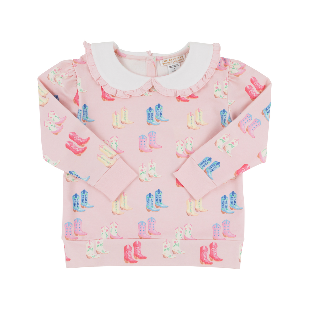 Pink sweater with colorful boot pattern on a white background