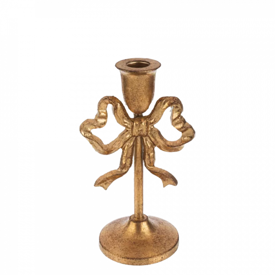 Decorative gold candle holder with bow design on a white background