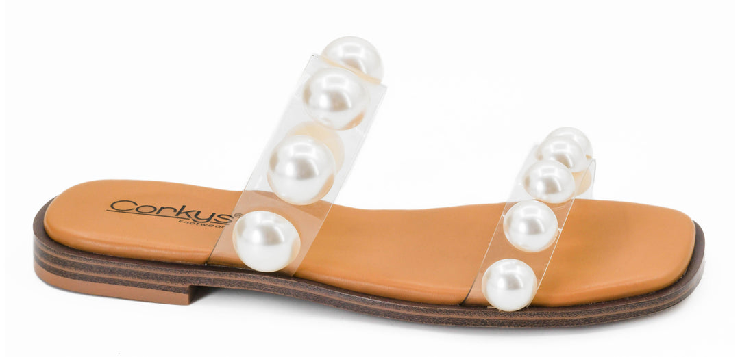 Sandal with pearl embellishments on a white background