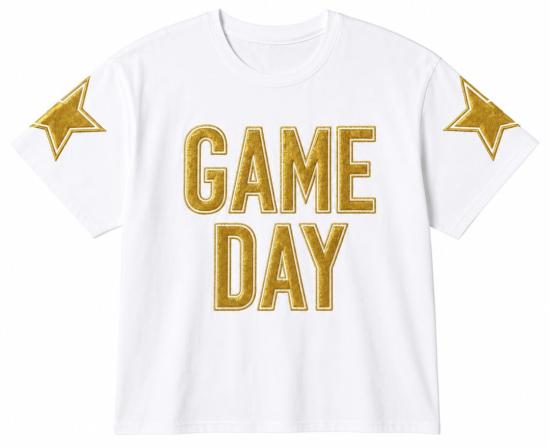 White t-shirt with 'GAME DAY' in gold letters and stars on shoulders against a white background
