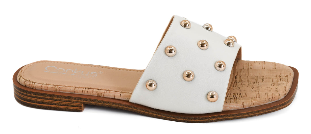 White slide sandals with gold dome studs, cork-style footbed, and flat slip-on design | Walker Boutique