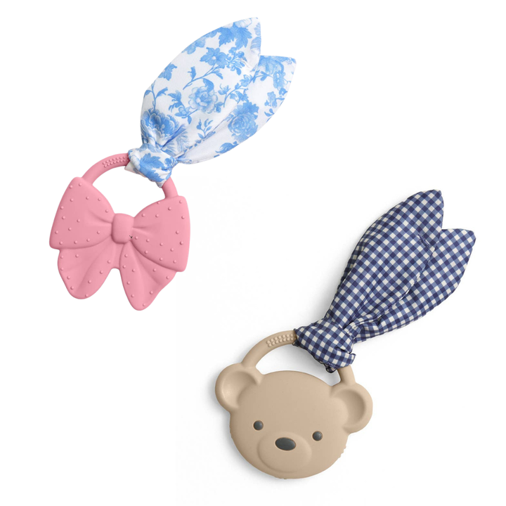 pink bow teether with blue & white crinkle attachment and taupe bear teether with blue check crinkle attachment on white background