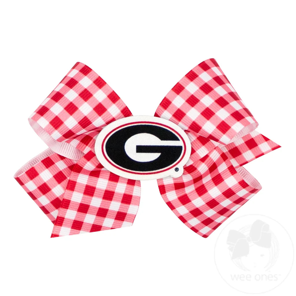 A red and white gingham ribbon hair bow featuring a Georgia Bulldogs logo emblem in the center.