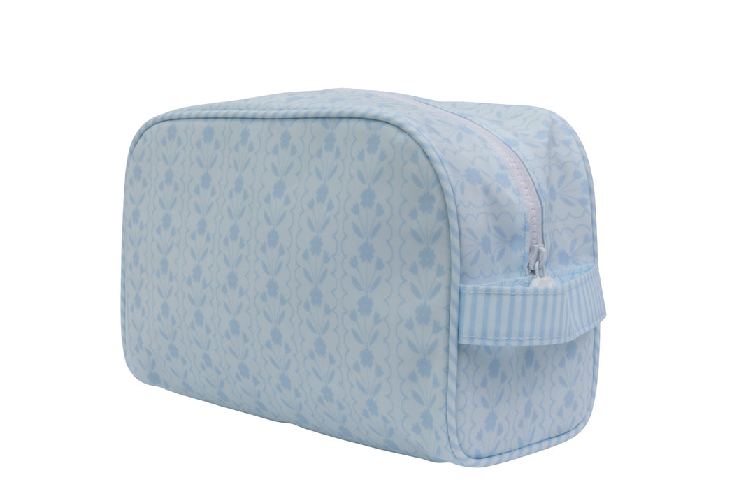 blue floral dopp kit bag on white background 
