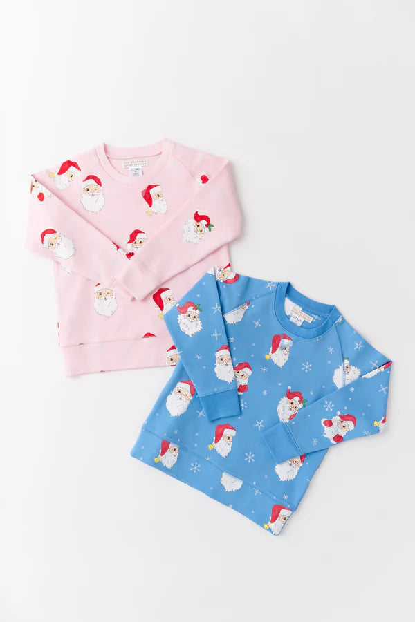 Two long-sleeve shirts, one pink and one blue, with Santa Claus pattern on a white background