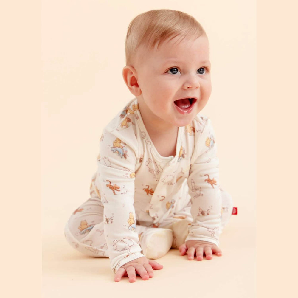 baby smiling in pooh bear footie