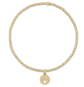 Gold beaded bracelet with a round charm on a white background