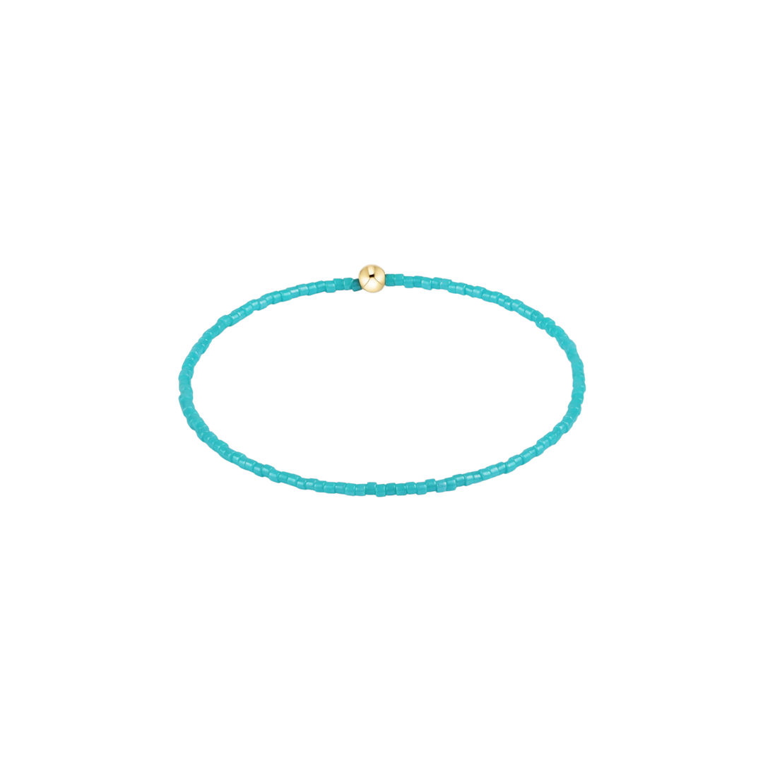 Turquoise beaded bracelet with a gold clasp on a white background