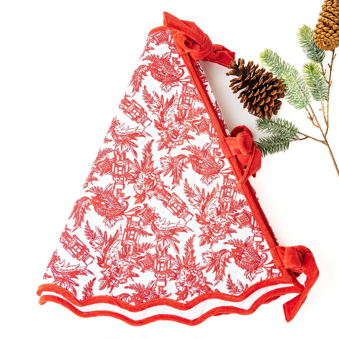 nutcracker toile print in red on white tree skirt, trimmed on red