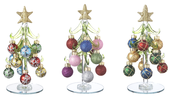 Three decorative Christmas trees made of colorful ornaments on clear stands.