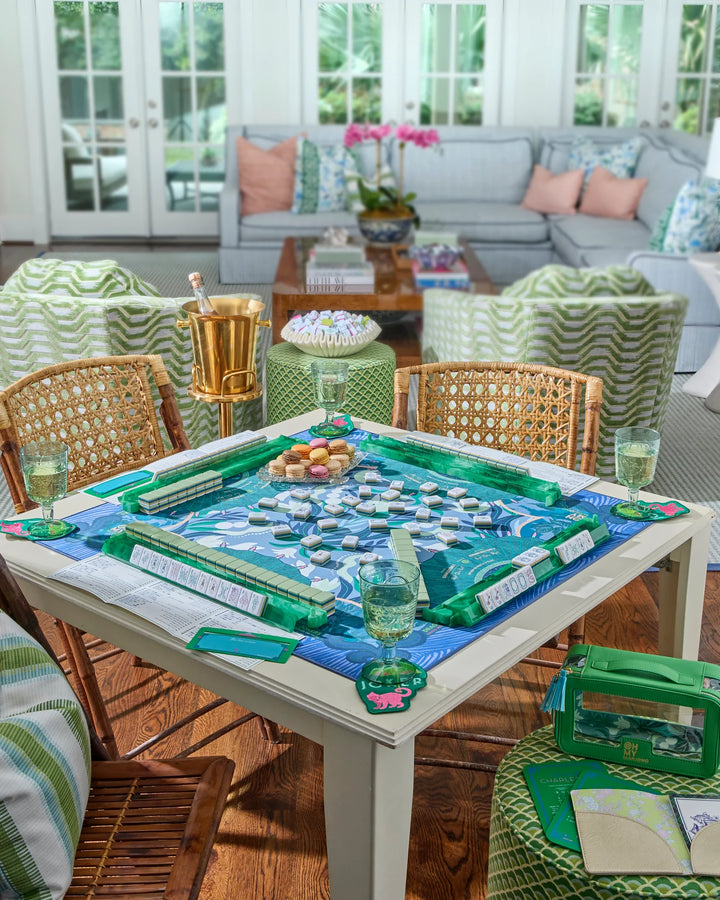 Outdoor patio with a table set for a game, surrounded by chairs and a couch.