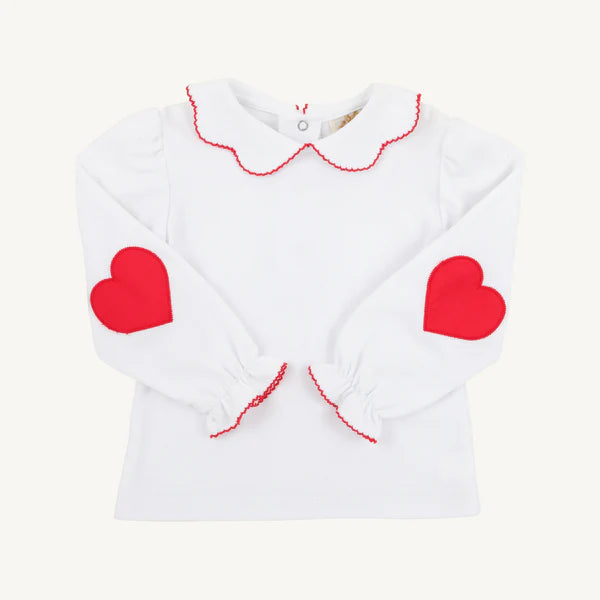 White blouse with red heart designs on a white background