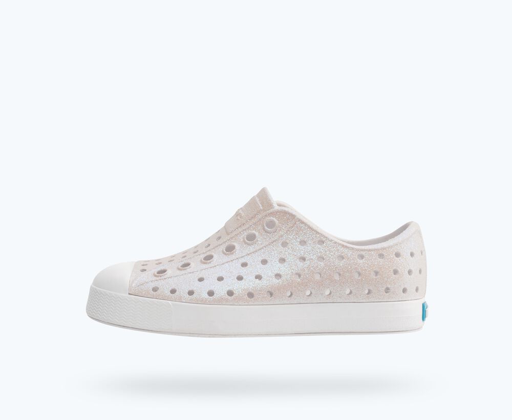 White slip-on sneaker with subtle pattern on a white background