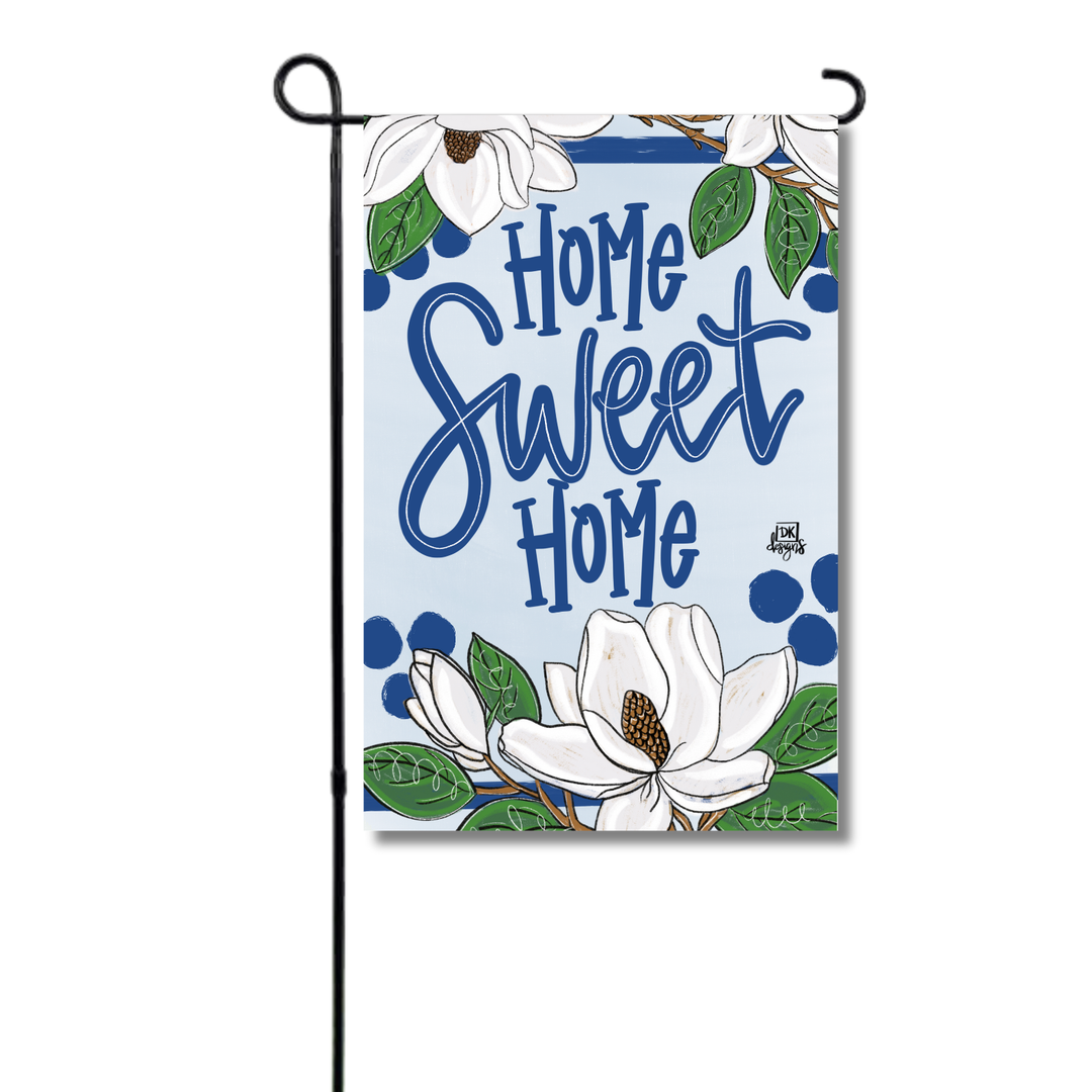 Decorative garden flag with 'Home Sweet Home' text and magnolia flowers on a white background.