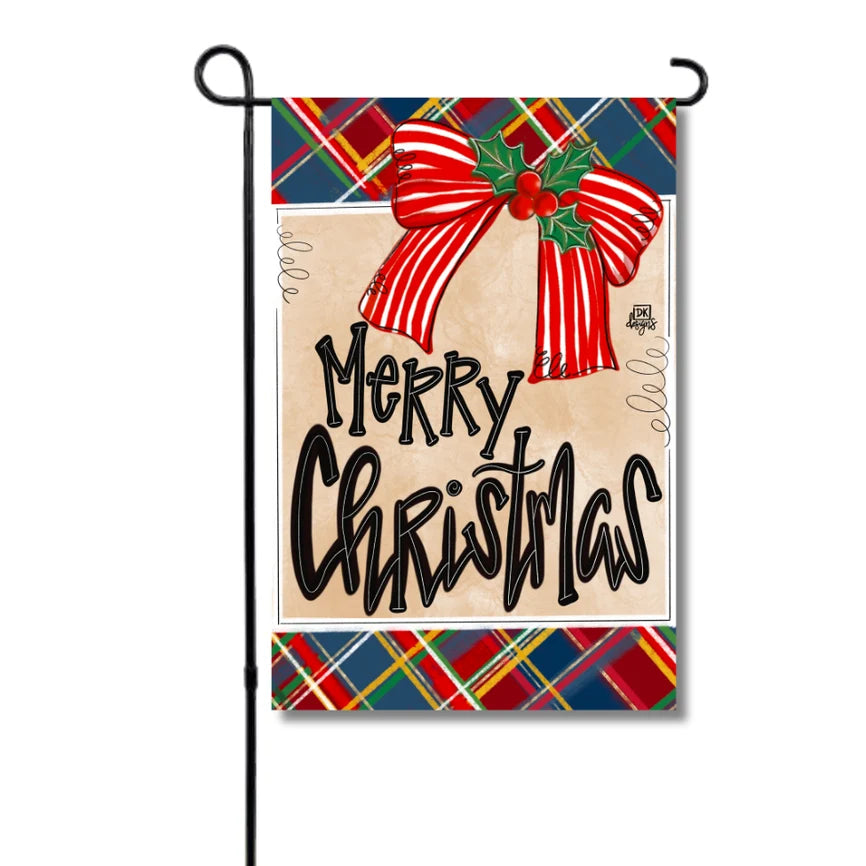 Christmas-themed garden flag with a red bow and plaid border on a white background