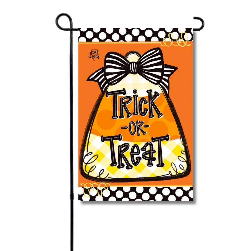 Halloween-themed garden flag with candy corn design and 'Trick or Treat' text on an orange background.