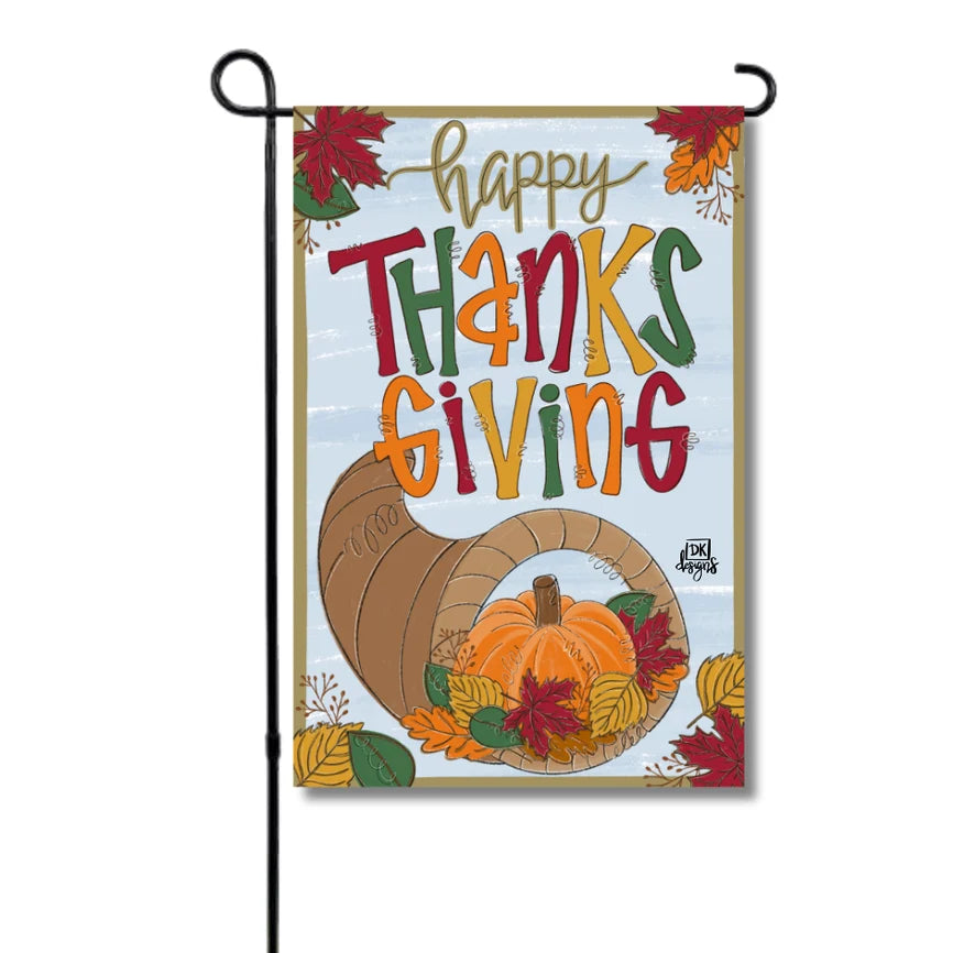 Decorative Thanksgiving garden flag with cornucopia, pumpkin, and fall leaves on a white background.