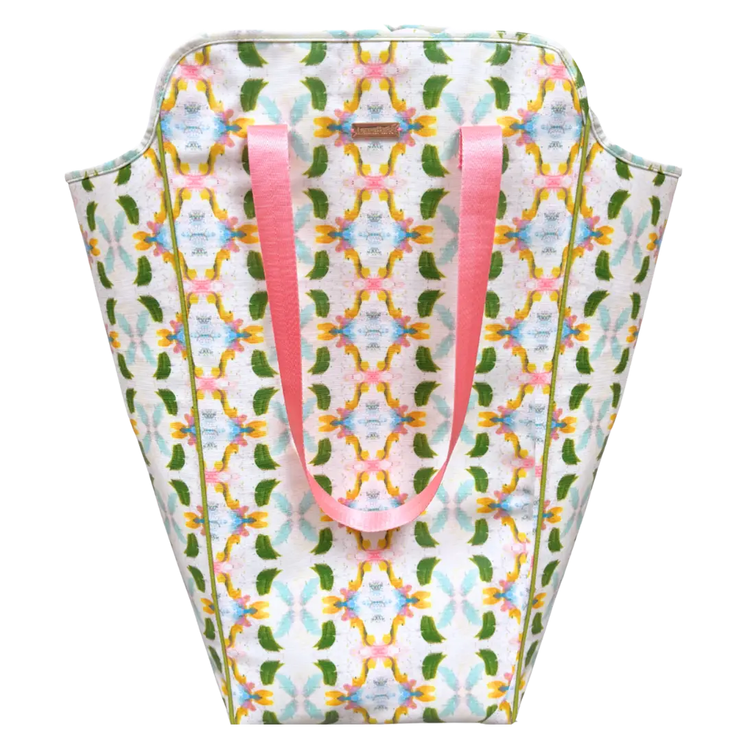 Patterned bag with pink handles on a white background