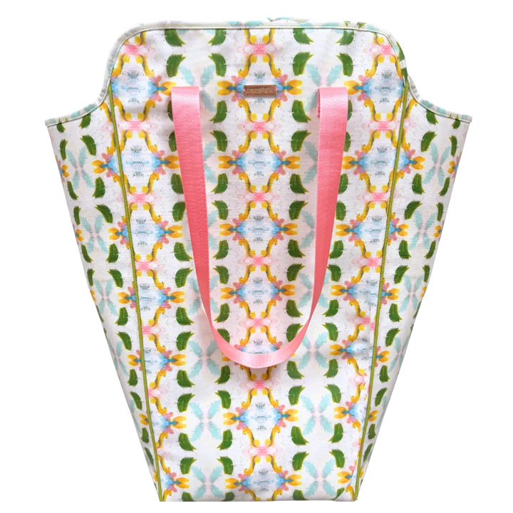 Patterned bag with pink handles on a white background