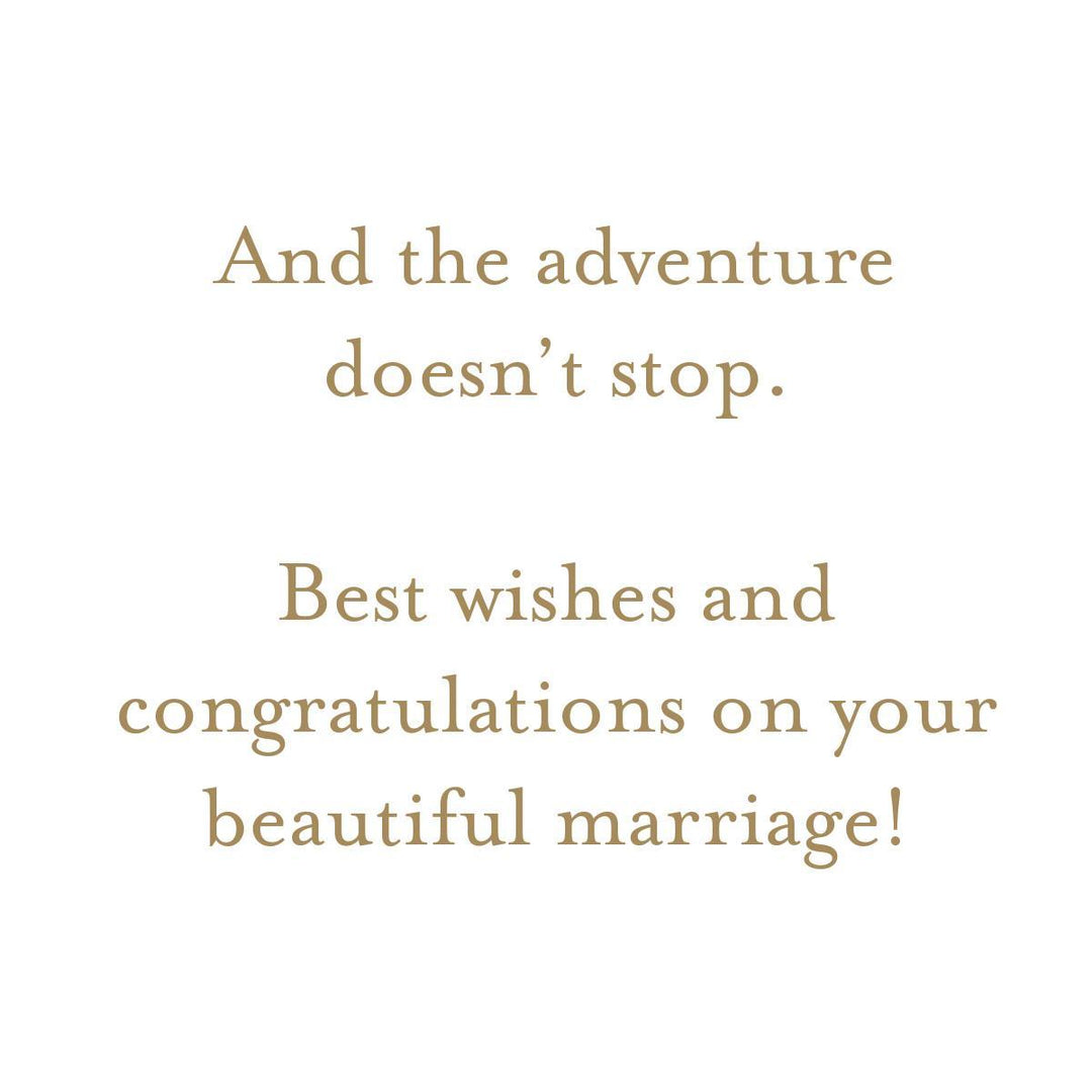 A square white card or print with centered tan serif text reading, 'And the adventure doesn't stop. Best wishes and congratulations on your beautiful marriage!'.
