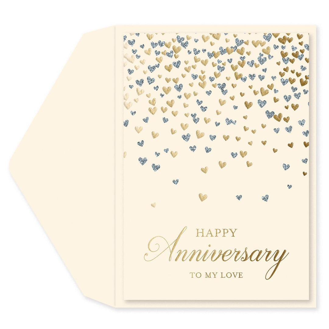 A cream-colored anniversary greeting card with a matching envelope. The card features a pattern of falling gold and blue glitter hearts, with 'HAPPY Anniversary TO MY LOVE' printed in elegant gold lettering at the bottom.