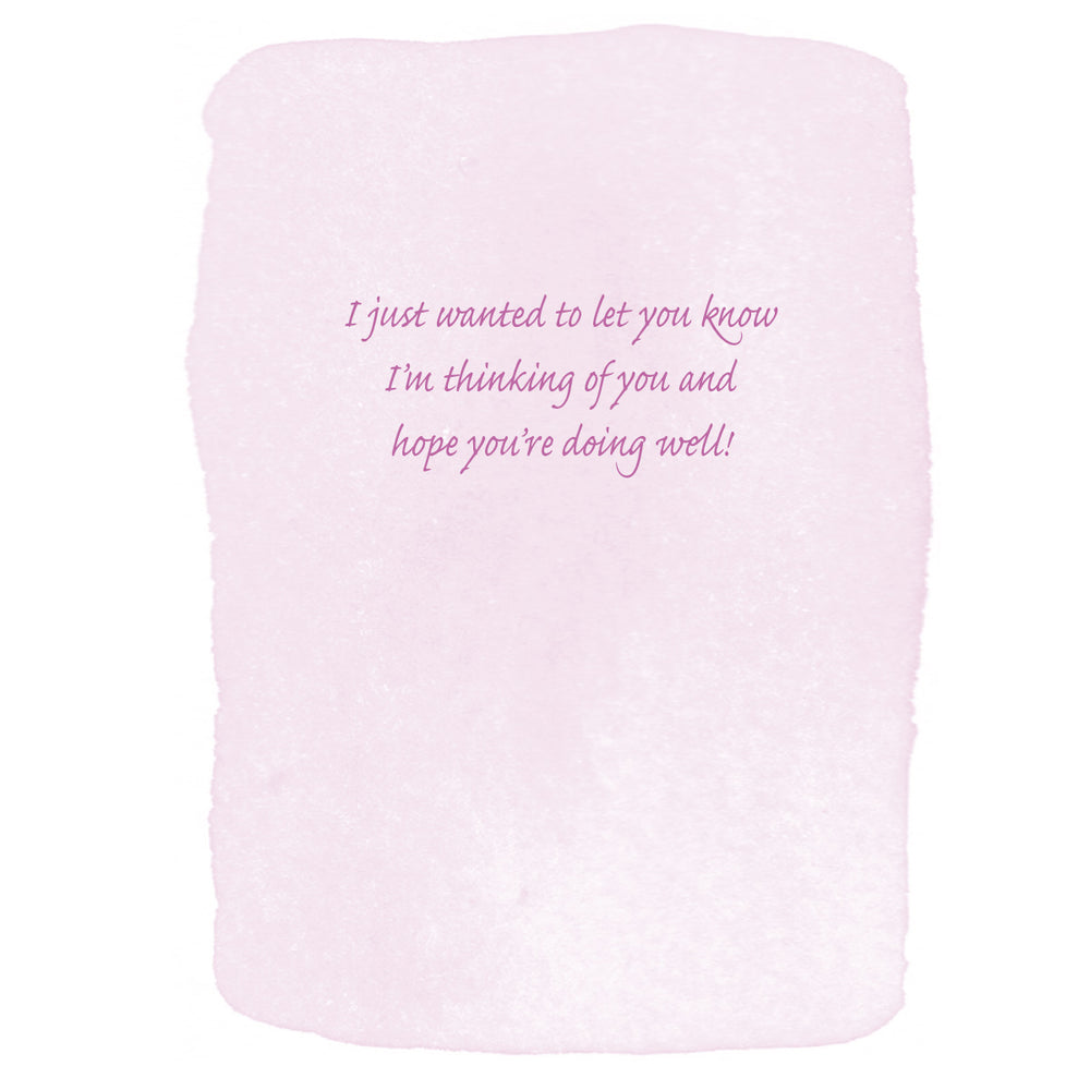 A square light pink textured card with hand-drawn rough edges and cursive purple text in the center reading, 'I just wanted to let you know I'm thinking of you and hope you're doing well!'.