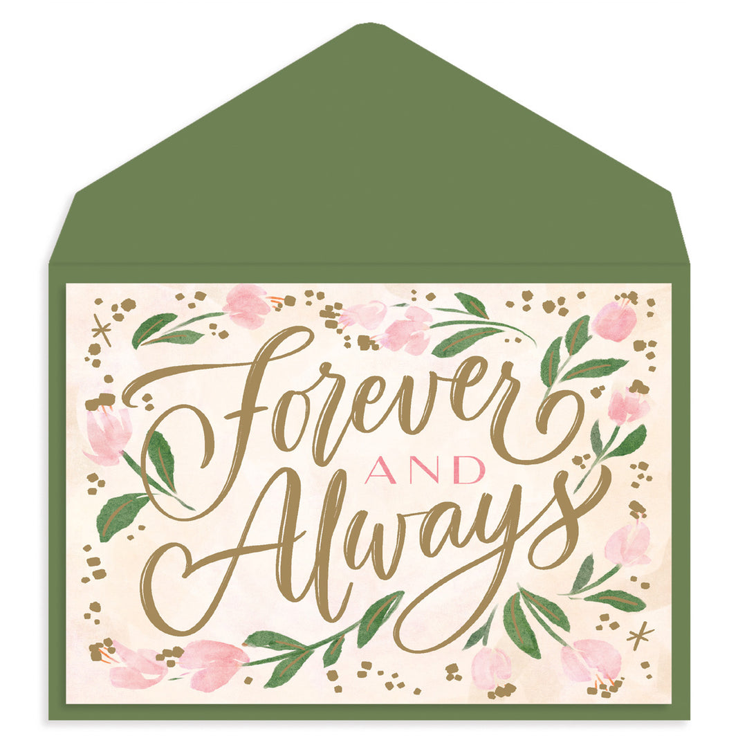 A square greeting card with a green envelope behind it. The card has a cream background with pink flowers, green leaves, and metallic gold script reading 'Forever and Always'.