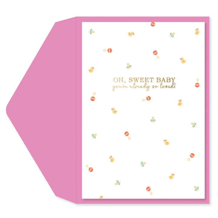 A baby shower greeting card and matching envelope set. The card features a white background with a border, decorated with small pastel illustrations of baby toys and the text 'OH, SWEET BABY you're already so loved!' in gold.