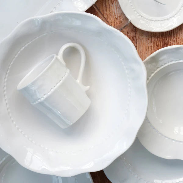 White ceramic cup and saucer on a wooden surface