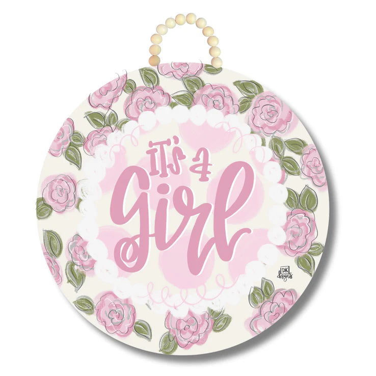 Decorative sign with floral design and 'It's a Girl' text on a white background