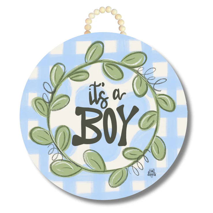Decorative sign with 'it's a boy' text on a blue and white checkered background