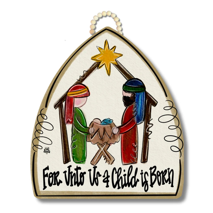 Hand-painted wooden Christmas nativity sign with a hanging loop at the top, featuring Mary, Joseph, baby Jesus in a manger, and a star, with the text 'For Unto Us a Child is Born' at the bottom.