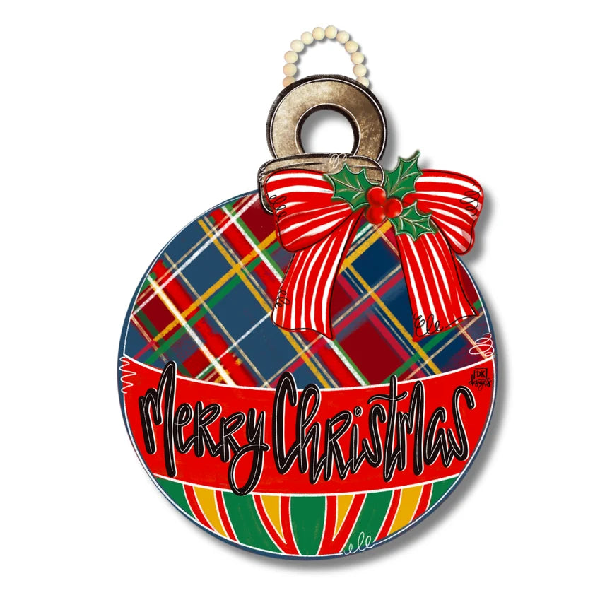 A round Christmas ornament featuring a red and green plaid pattern, a red and white striped bow with holly, and the words 'Merry Christmas' in black script on a red banner, shown on a white background.