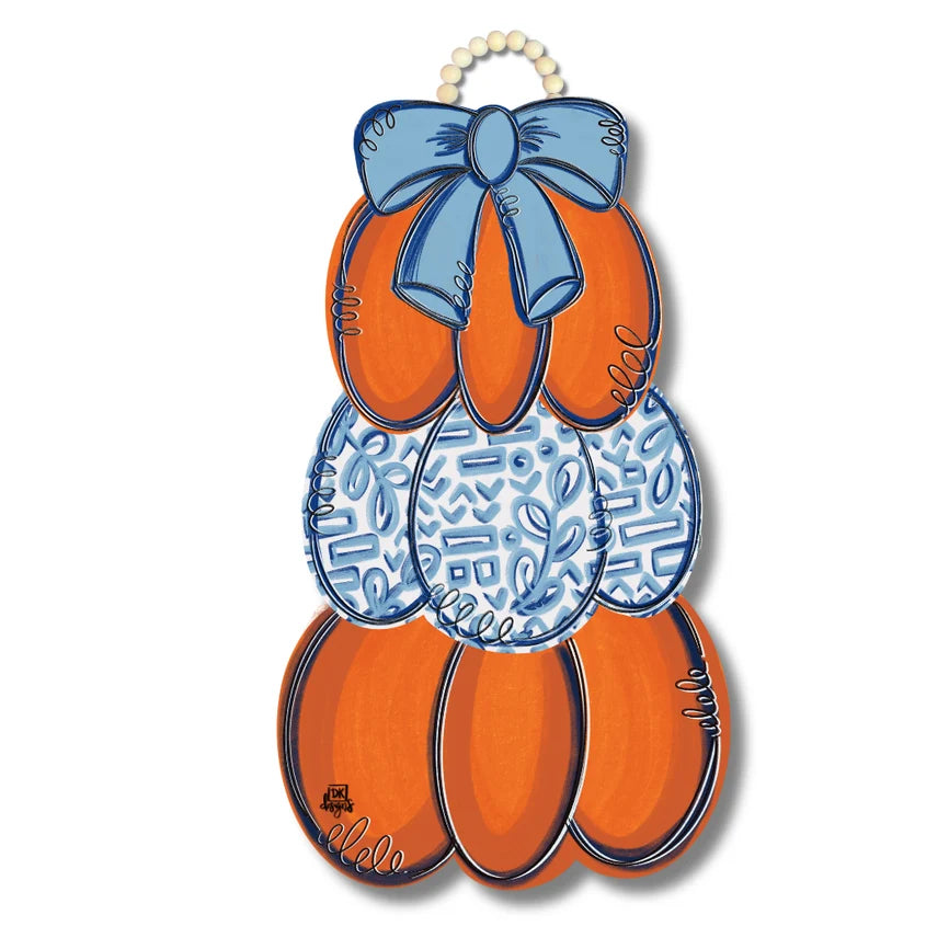 Decorative wall hanging with orange shoes and blue bow on a white background