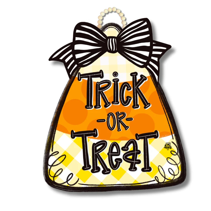 A Halloween decorative sign shaped like a bell, featuring the words 'Trick or Treat' in black lettering over an orange and yellow gingham pattern. The top of the bell has a black-and-white striped bow and a hanging loop at the top, shown on a white background.