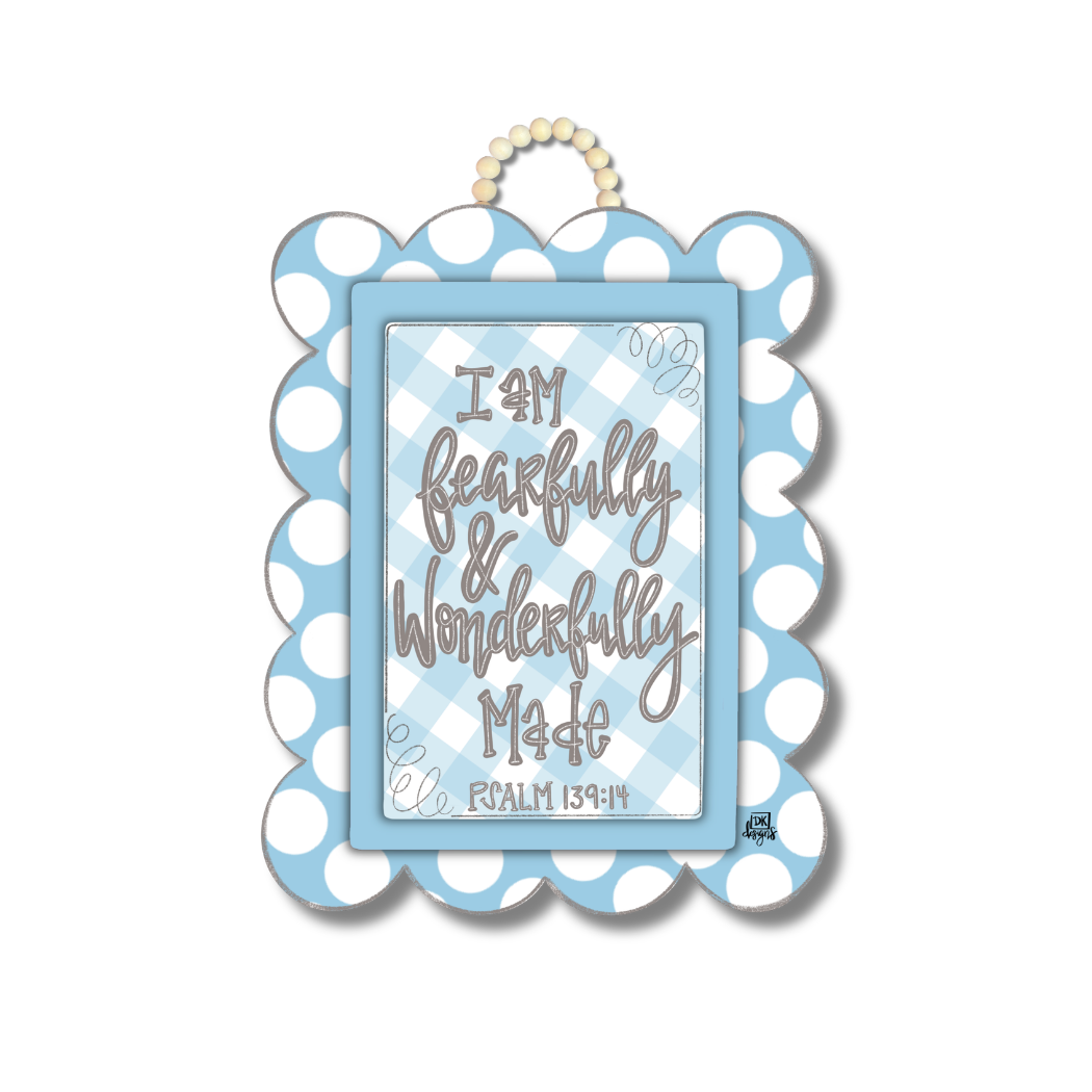 Decorative wall hanging with polka dot border and motivational quote on a white background