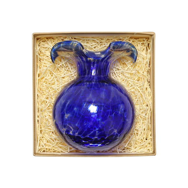 Blue glass vase in a decorative box with straw-like filler
