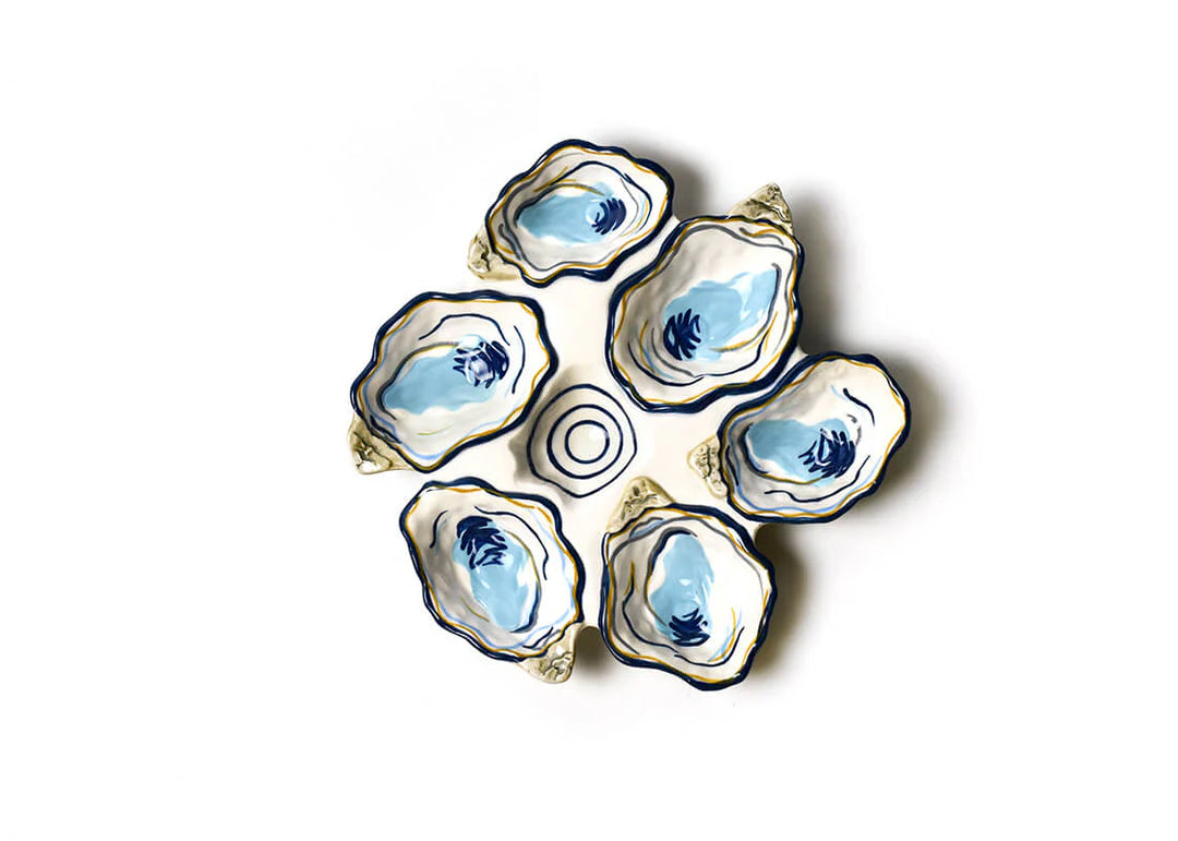 Set of five ceramic oyster dishes with blue interior on a white background