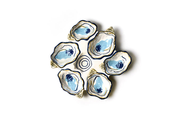 Set of five ceramic oyster dishes with blue interior on a white background