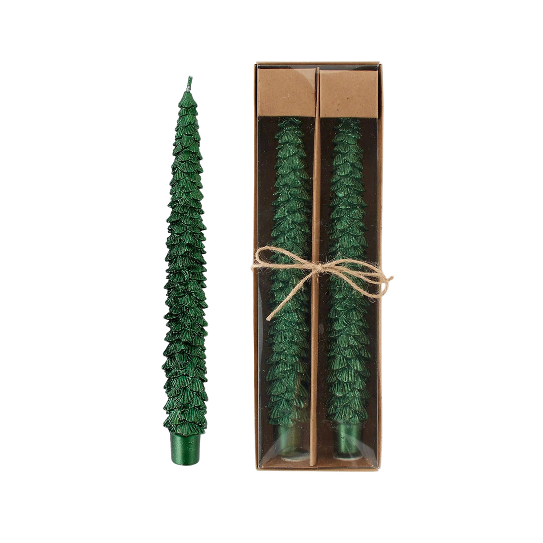 Green tree-shaped candles in a cardboard box on a white background