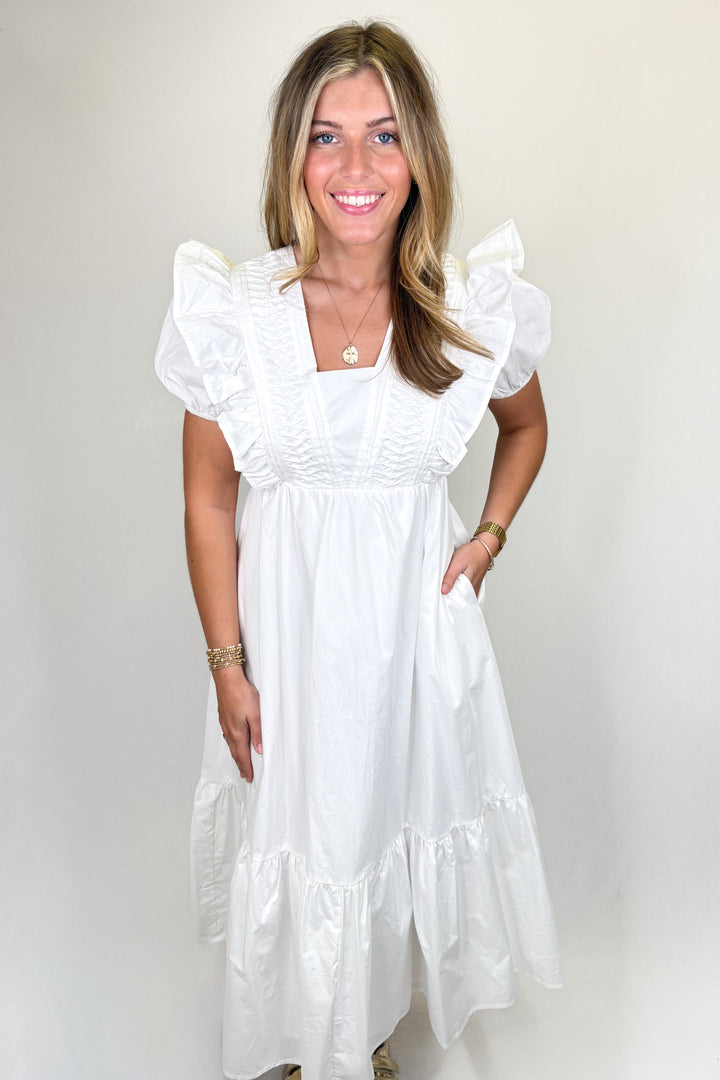 White Maxi Dress with ruffle sleeves, pleated bodice, and tiered skirt with pockets | Walker Boutique