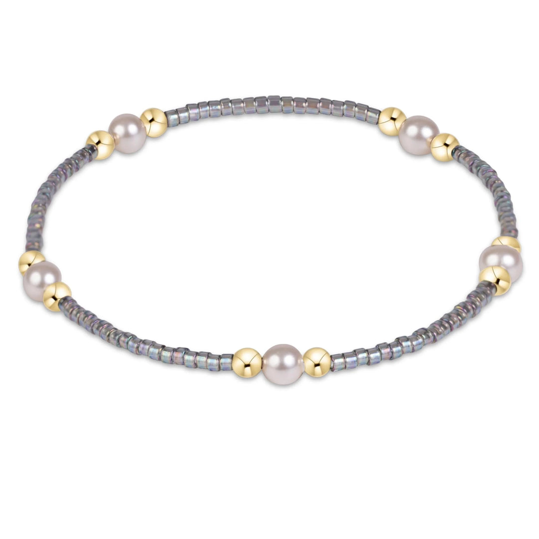 GRAY BEADED BRACELET WITH GOLD AND PEARL CLUSTERS ON WHITE BACKGROUND