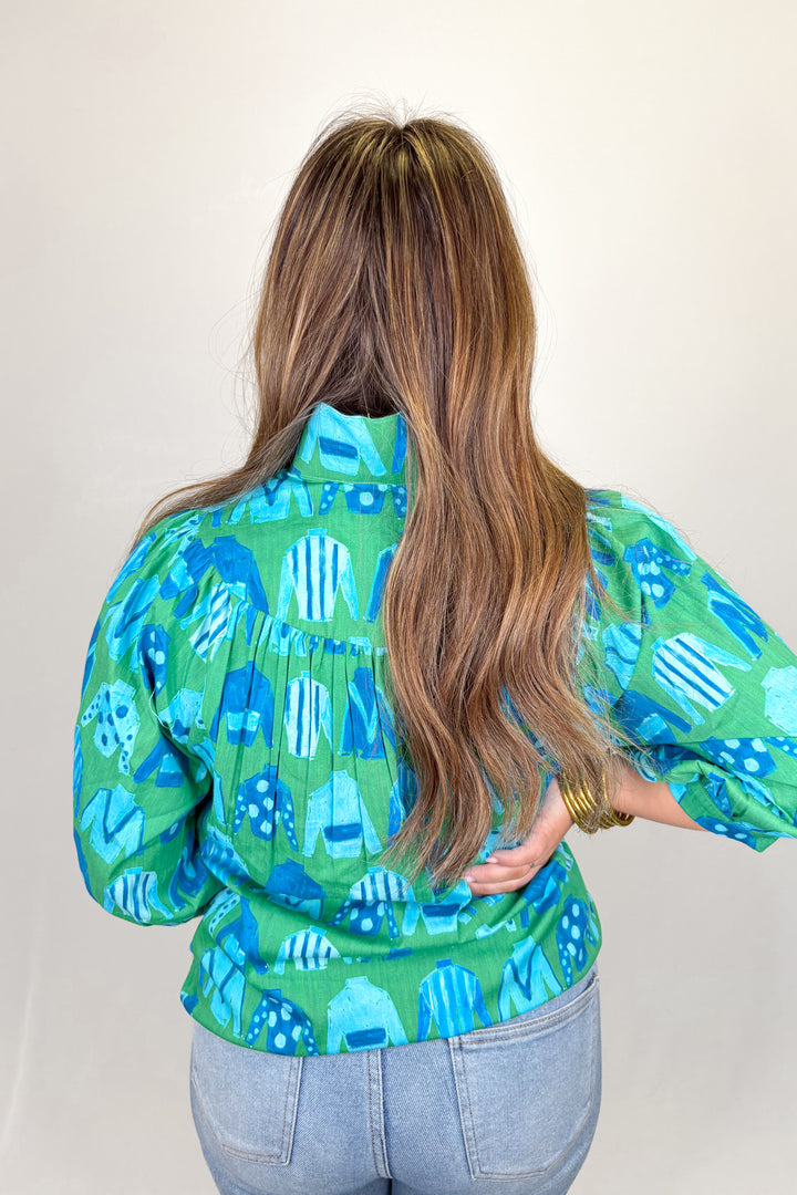 Person wearing a colorful patterned shirt with long hair