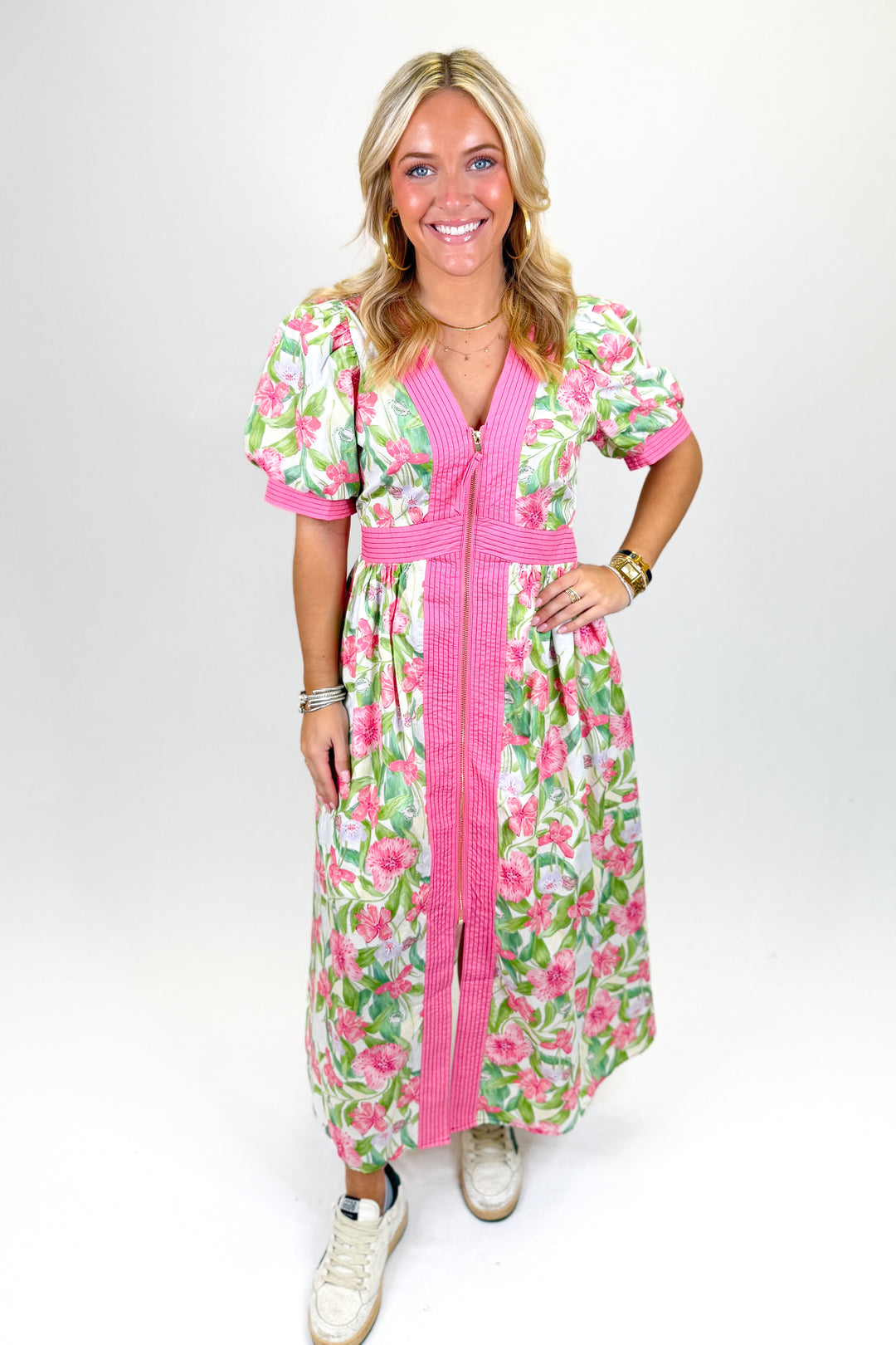 Woman wearing a floral midi dress with zipper front.