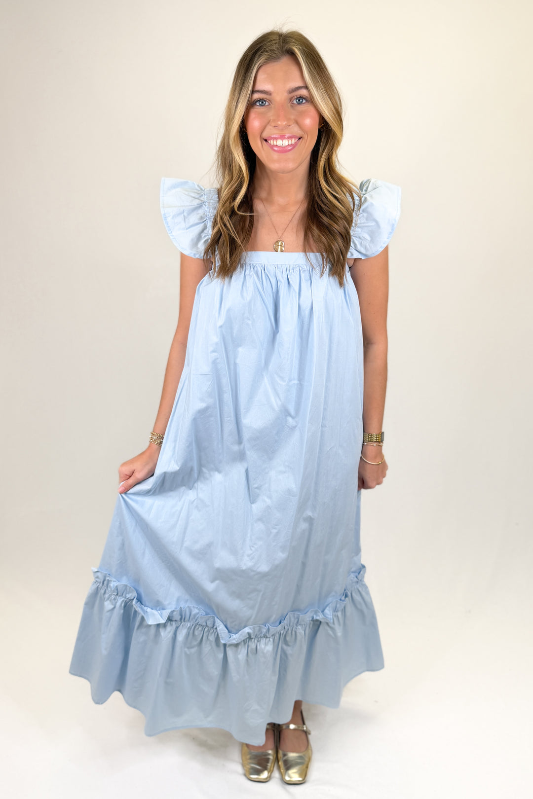 Woman wearing a baby blue midi dress.