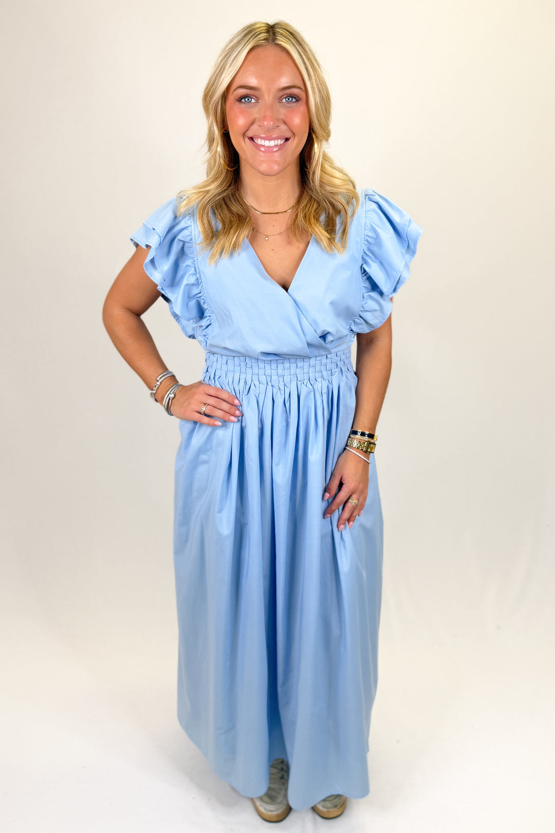Woman wearing a light blue midi dress.