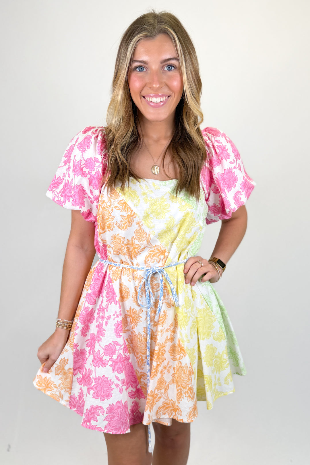 Woman wearing a multi color floral print dress.