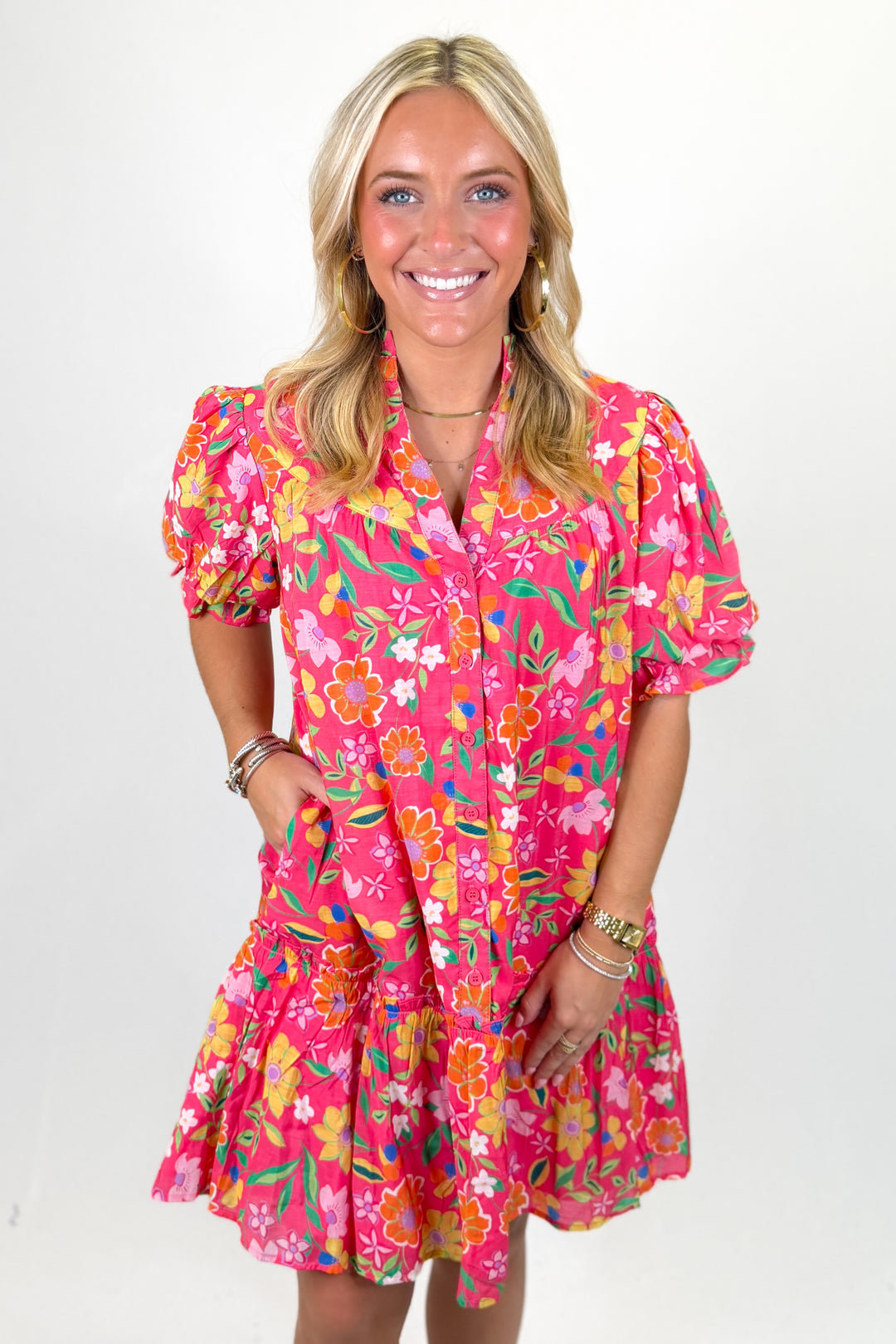 Woman wearing a hot pink floral printed short dress.